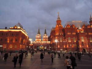 Beautiful evening view of Red Square in Moscow with a lively crowd.
